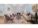 Bright living room featuring hardwood floors, a decorative rug, comfortable seating, and arched doorways at 1467 Clermont St, Denver, CO 80220