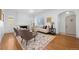 Bright living room featuring hardwood floors, a decorative rug, comfortable seating, and arched doorways at 1467 Clermont St, Denver, CO 80220