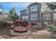 Spacious backyard with tiered deck, red railings, and mature trees, perfect for outdoor living at 4431 W Jamison Pl, Littleton, CO 80128