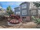 Home backyard featuring multilevel deck and mature trees providing privacy and shade at 4431 W Jamison Pl, Littleton, CO 80128