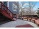 Inviting backyard featuring a multi-level deck, red railings, and stairs to the grassy yard at 4431 W Jamison Pl, Littleton, CO 80128