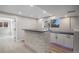 Basement bar features stone accents and modern finishes creating a stylish and functional space for entertaining guests at 4431 W Jamison Pl, Littleton, CO 80128