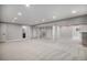 Expansive basement featuring neutral carpet and lighting, offering ample space for various activities at 4431 W Jamison Pl, Littleton, CO 80128