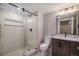 Modern bathroom with stylish tile shower, glass doors, and vanity with sleek fixtures at 4431 W Jamison Pl, Littleton, CO 80128
