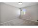 This is a gray bedroom featuring gray carpet, and a window with natural light at 4431 W Jamison Pl, Littleton, CO 80128