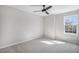 This is a gray bedroom featuring gray carpet, and a window with natural light at 4431 W Jamison Pl, Littleton, CO 80128
