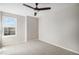 Bright bedroom features a ceiling fan and a window providing natural light at 4431 W Jamison Pl, Littleton, CO 80128