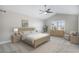 Light-filled bedroom with a ceiling fan, neutral color scheme, and large windows at 4431 W Jamison Pl, Littleton, CO 80128