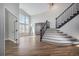 Bright entryway featuring hardwood floors, high ceilings, and a staircase with iron railings at 4431 W Jamison Pl, Littleton, CO 80128