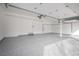 Bright, clean garage with epoxy flooring, ample space for vehicles and storage, door to outside at 4431 W Jamison Pl, Littleton, CO 80128
