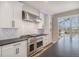 A beautifully renovated kitchen with stainless steel appliances and white cabinetry at 4431 W Jamison Pl, Littleton, CO 80128