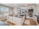 Spacious kitchen island overlooks the living room with a fireplace and custom shutters at 4431 W Jamison Pl, Littleton, CO 80128