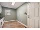 Convenient laundry room area with wood-look tile flooring, storage and modern accents at 4431 W Jamison Pl, Littleton, CO 80128