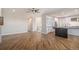 Open living space with hardwood floors that leads to a kitchen with granite counters at 4431 W Jamison Pl, Littleton, CO 80128