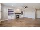 Spacious living room featuring a fireplace, built-in shelves, and hardwood floors at 4431 W Jamison Pl, Littleton, CO 80128