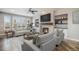 Cozy living room with a fireplace, recessed lighting, and large windows that flood the room with natural light at 4431 W Jamison Pl, Littleton, CO 80128