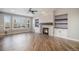 Open living room features a cozy fireplace and tons of natural light from the large windows at 4431 W Jamison Pl, Littleton, CO 80128