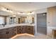 Luxury main bathroom features dual sinks, wood cabinets, and an adjacent room with a shower and tub at 4431 W Jamison Pl, Littleton, CO 80128