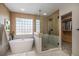 Bright bathroom with a soaking tub, walk-in shower, and stylish fixtures at 4431 W Jamison Pl, Littleton, CO 80128