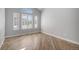 Bright room showcasing wood floors and large windows with plantation shutters at 4431 W Jamison Pl, Littleton, CO 80128