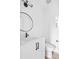 Modern bathroom featuring a sleek vanity with black hardware and round mirror, complemented by a contemporary toilet at 1346 N Knox Ct, Denver, CO 80204