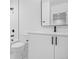 Modern bathroom with white cabinets, updated fixtures, and shower-tub combo at 1346 N Knox Ct, Denver, CO 80204