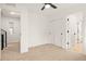 Bright, carpeted bedroom with a ceiling fan, access to a closet and hallway at 1346 N Knox Ct, Denver, CO 80204