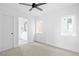Clean, carpeted bedroom with two windows and access to an attached bathroom at 1346 N Knox Ct, Denver, CO 80204