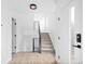 Bright foyer with light wood-style flooring, modern lighting and a carpeted staircase at 1346 N Knox Ct, Denver, CO 80204