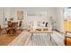 Cozy living room featuring stylish decor and a modern rug, seamlessly connected to a dining area with table and chairs at 1346 N Knox Ct, Denver, CO 80204