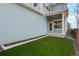 Low-maintenance backyard with artificial turf and blue siding, perfect for relaxing at 21209 E 62Nd Ave, Aurora, CO 80019