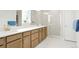 Bathroom boasts double sink vanity, quartz countertops, and glass enclosed shower at 21209 E 62Nd Ave, Aurora, CO 80019