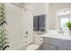 Bright bathroom featuring white subway tile, modern fixtures, and white cabinets at 21209 E 62Nd Ave, Aurora, CO 80019