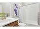 Bathroom featuring a white tiled shower and modern vanity with brushed gold fixtures at 21209 E 62Nd Ave, Aurora, CO 80019
