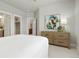 Bright bedroom features soft neutral decor, luxury vinyl floors, and ample natural light at 21209 E 62Nd Ave, Aurora, CO 80019