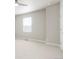 Bedroom features a large window for natural light and neutral decor at 21209 E 62Nd Ave, Aurora, CO 80019