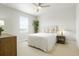 This light-filled bedroom features neutral decor, soft carpet, and a ceiling fan at 21209 E 62Nd Ave, Aurora, CO 80019