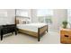 Bright bedroom featuring neutral decor, ample natural light, and soft carpeting at 21209 E 62Nd Ave, Aurora, CO 80019