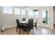 Bright dining area with modern light fixture, white trim and an exterior door to the backyard at 21209 E 62Nd Ave, Aurora, CO 80019