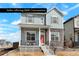Charming two-story home featuring a welcoming front porch and modern stone accents at 21209 E 62Nd Ave, Aurora, CO 80019