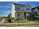 Charming two-story home with light blue siding, stone accents, landscaped yard and a welcoming front porch at 21209 E 62Nd Ave, Aurora, CO 80019