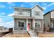 Charming two-story home featuring stone accents, a welcoming front porch, and a well-manicured yard at 21209 E 62Nd Ave, Aurora, CO 80019
