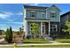 Charming two-story home with light blue siding, stone accents, landscaped yard and a welcoming front porch at 21209 E 62Nd Ave, Aurora, CO 80019