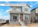 Charming two-story home featuring a cozy front porch and stylish stone accents, perfect for modern living at 21209 E 62Nd Ave, Aurora, CO 80019