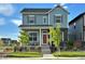 Charming two-story home showcasing a blue exterior, stone accents, and a welcoming front porch at 21209 E 62Nd Ave, Aurora, CO 80019