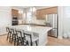 Modern kitchen with stainless steel appliances, large island, and stylish pendant lighting at 21209 E 62Nd Ave, Aurora, CO 80019