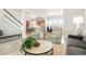 Comfortable living room with an open floor plan view of the modern kitchen and dining area at 21209 E 62Nd Ave, Aurora, CO 80019
