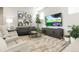 Cozy living room boasts large tv and modern decor and comfortable seating for entertaining or relaxing at 21209 E 62Nd Ave, Aurora, CO 80019