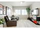 Relaxing living room area featuring comfortable chairs, modern decor and streaming sunlight from the windows at 21209 E 62Nd Ave, Aurora, CO 80019