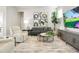 Inviting living room featuring stylish sofas, modern decor, and a wall-mounted TV for relaxation and entertainment at 21209 E 62Nd Ave, Aurora, CO 80019